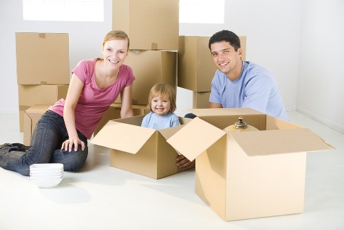 Moving team handling boxes safely during a van loading operation