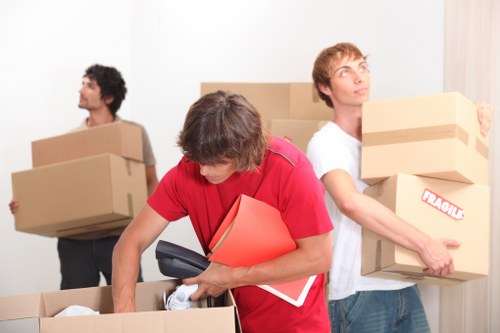 Professional movers managing office furniture transport in Waterloo with careful loading